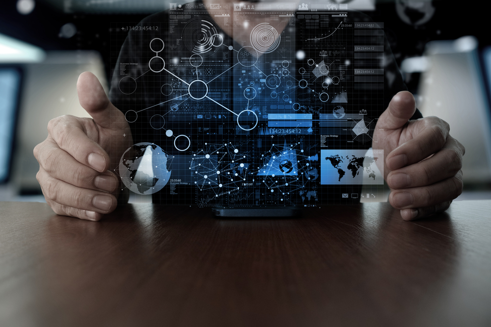 Businessman holding a mobile phone with a digital data overlay, representing omnichannel commerce strategy
